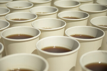 Tea in glasses. Lots of white drinking glasses. Tea on the street.