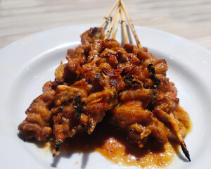 Chicken skin satay with peanut sauce on white plate, deep of field selective focus. Can be used for food menu photos.