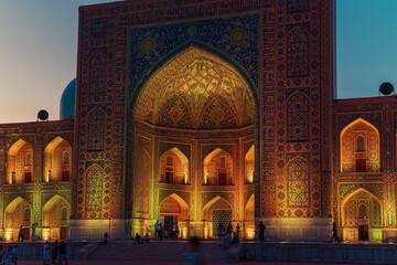 Tilla-Kari (Tilya-Kori) Madrasah on Registan Square illuminated at night.