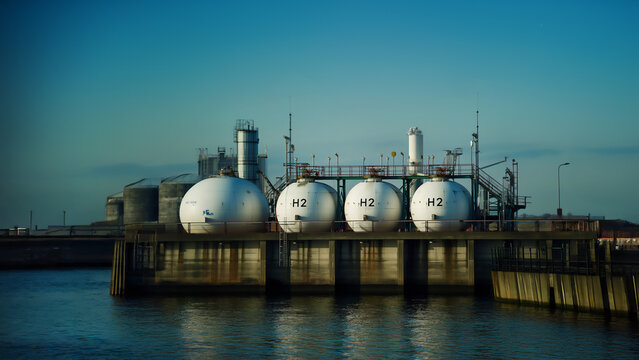 Hydrogen storage tanks on coastal terminal pier. Clean energy, green transition concept. H2 containers. Sustainable fuel technology, renewable power generation, eco-friendly transportation solutions - Powered by Adobe
