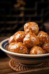 Beef meatballs on wooden table, interior scene with dark background