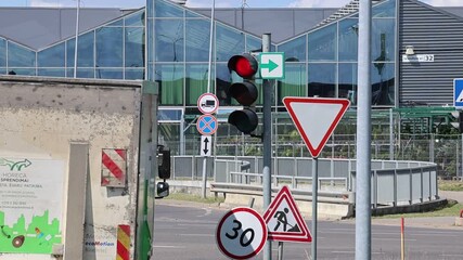 Traffic in Kaunas city with green arrows at traffic lights, allowing right turns at intersections