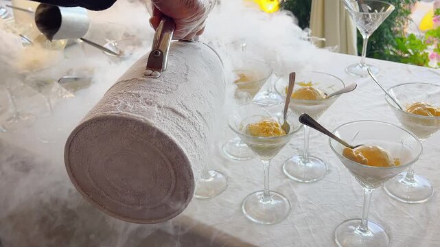 Waiters prepare ice cream. Making ice-cream with liquid nitrogen, chef show. Birthday party outdoor.