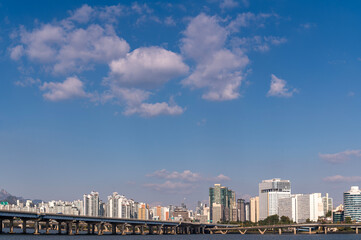 Obraz premium Seoul cityscapes, skyline, high rise office buildings and skyscrapers with blue sky and cloud in Seoul city, winter daylight, top view in winter, Seoul, Republic of Korea,