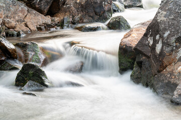 waterfall in the woods of Andalsnes Norway in summer evening fjord