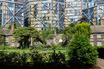 London - 06 10 2022: Hopton's Almshouses garden and houses among modern buildings