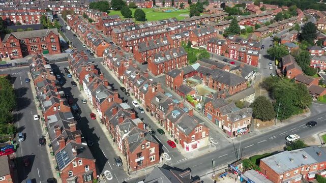 Aerial drone footage of the village of Headingley in Leeds, West Yorkshire in the UK showing the rows of houses in the residential area in the British town in the summer time