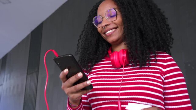  Young African American woman browsing the Internet smart mobile application