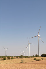  Wind turbines in a dry landscape under a clear sky