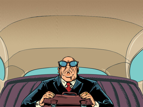 An important male businessman in glasses is driving in a car. A serious boss gets to work. VIP client and his safety.