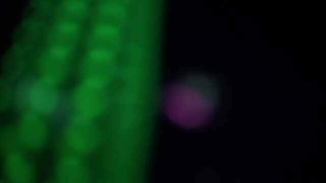 Abstract and blurred background of circles of light, quickly mutating and changing in intensity and color. Real time 4K video.