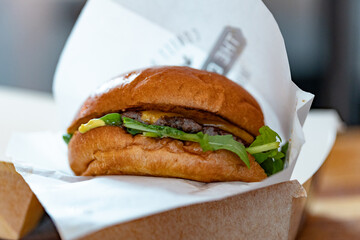 Fresh burger with beef, salad and cheese at a food stall on the market square.