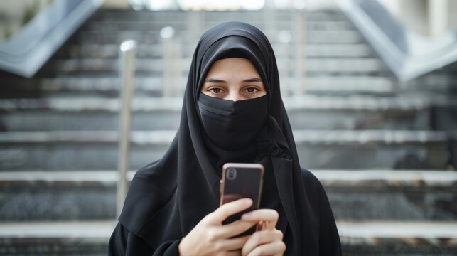 young modern muslim business woman using smartphone wearing hijab clothes