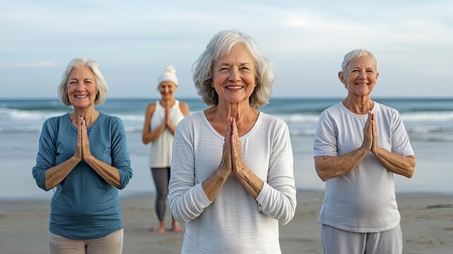Close-up Seniors participating in a yoga class on the beach, celebrating International Day of Older Persons, promoting health and happiness, with the ocean and sunrise in the background, copy space - Powered by Adobe