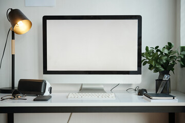 Computer monitor and VR glasses on table in the room