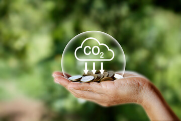 Carbon credit market and net zero concept. gold coin on hand.and upward arrow represent carbon...