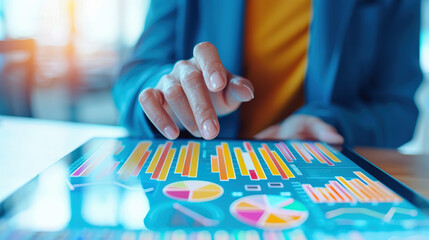 Close-up of a person strategic planner with a digital tablet, analyzing colorful graphs and charts on a digital tablet, depicting data analysis and business growth.
