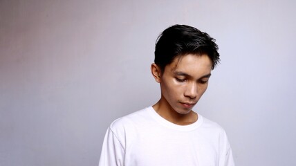 close up of handsome asian young man wearing white shirt