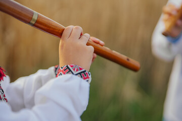 Hands Of Little Boy Kid Playing On Woodwind Wooden Flute - Ukrainian Sopilka