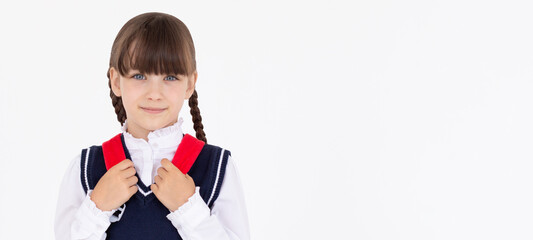 Indoor picture of young good-looking teenage girl isolated on white background in school uniform,...