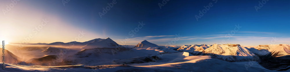 Wall mural a panoramic view of a snowy mountain range with a sun setting in the background