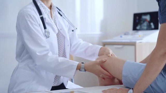 Doctor is carefully examining a patient's knee, providing personalized care and support. Medicine and orthopedic concept