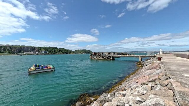 Fishing gear and jetty in Brixham harbour on the Devon coast. Captured on a bright and sunny summer day