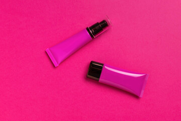 Cosmetic Tubes on Vibrant Pink Background Beauty Product Mockup and Skincare Packaging Design