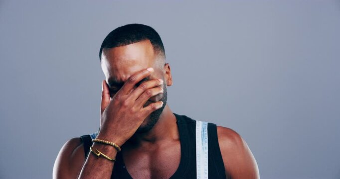 Depression, crying and face of black man in a studio with upset, worry and sad expression. Emotions, grief crisis and portrait of young African male person with tears isolated by gray background.