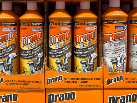 On the display are a row of orange bottles of Drano drain cleaner. The bottles are lined up, some taller than others.