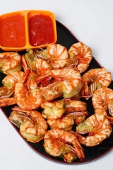 Fried prawn or fried shrimps sauteed with salt and pepper and garlic served in plate, good for cooking book ora recipes or multimedia cooking content
