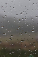Raindrops on a windowpane, capturing the serene and introspective mood of a rainy day.