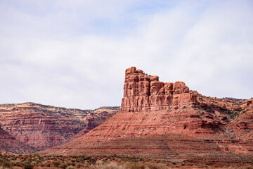 Fototapeta premium Breathtaking view of a majestic rock formation formed by erosion in the Valley of the Gods, Utah, USA. This picturesque landscape showcases the rugged beauty of nature - USA