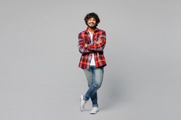Full body young happy smiling confident Indian man he wears red shirt casual clothes look camera...