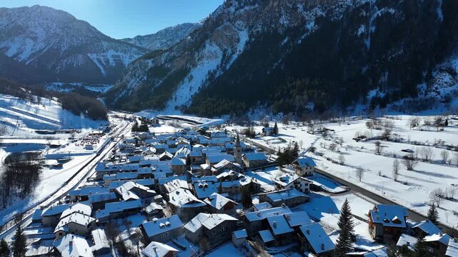 Panoramic view from above at nightfall of the snowy village of Bardonecchia, a ski resort in the Alps in Piedmont, Italy.