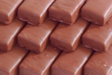 The diagonal arrangement with chocolate bars. The sweet food in stack.