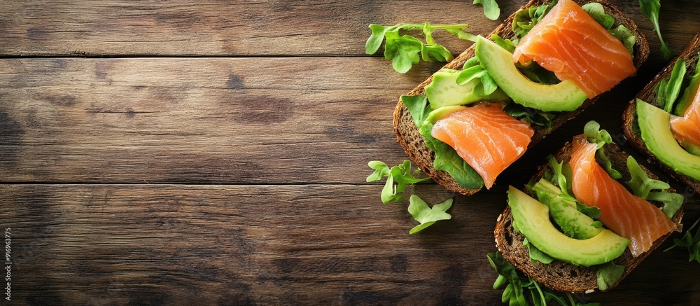 Aufkleber whole grain rye bread toast topped with salmon and avocado set against a wooden table background a n