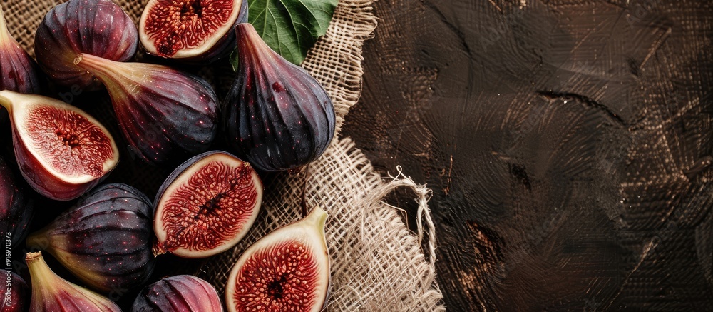 Poster horizontal sackcloth background with a mix of whole figs and a single sliced fig bringing focus to t