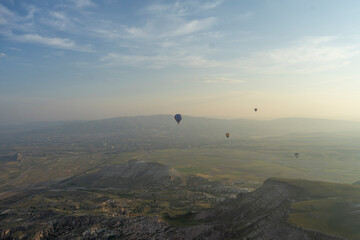 Hot air balloons floating over the strangely rocky region of Cappadocia