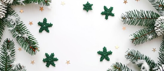 Scandinavian handmade Christmas composition featuring crocheted green snowflakes and stars on a white background with a top view flat lay showcasing a copy space image