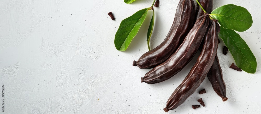Aufkleber ripe carob on a white backdrop with copy space image