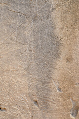 Old foundation and plaster wall with cracks. Building requiring repair closeup.