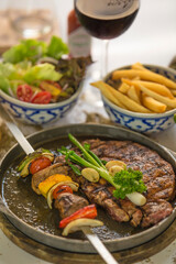 steak and shish kebab on a plate with salad and french fries middle east arab style 