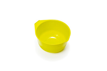 Measuring plastic cup isolated on white background. Kitchen measuring cup yellow.