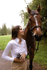 Fototapeta premium beautiful woman with dark hair posing with horse