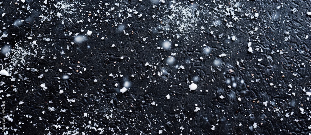 Aufkleber a wide photo featuring snow falling on asphalt from above with copy space image