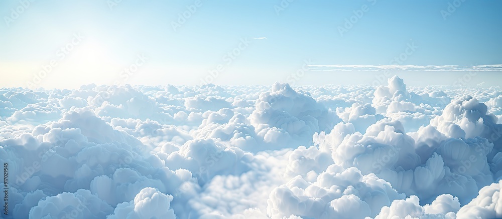 Poster an aerial perspective revealing fluffy clouds during a bright day with a clear sky providing ample c