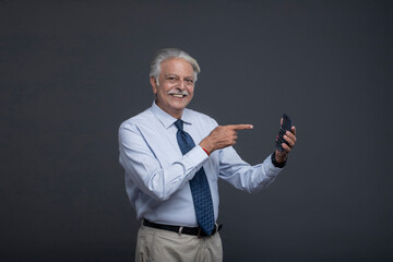 Aged Man Smiling And Showing His Calculator