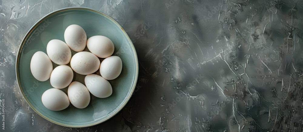 Poster directly above shot of white eggs in bowl on table with ample copy space for a fresh and healthy raw