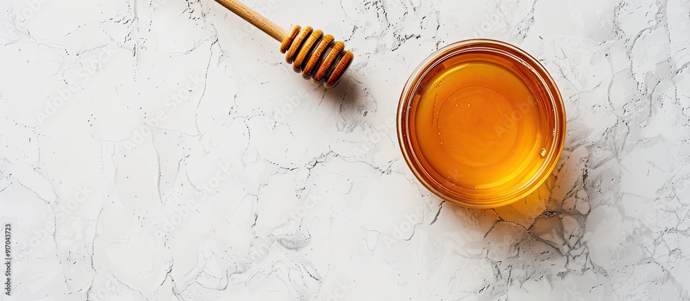 Poster A delicious honey jar with a wooden honey dipper placed on a white surface captured from above with room around for text in the image. copy space available